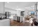 Modern, open-concept kitchen with white cabinets, an island, and stainless steel appliances at 17449 Luminous Ave, Venice, FL 34293