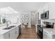Well-designed kitchen with island, stainless steel appliances, and white cabinets, flowing into living space at 17449 Luminous Ave, Venice, FL 34293