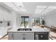 Open-concept kitchen and living area with a large island and lots of natural light at 17449 Luminous Ave, Venice, FL 34293