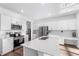 Bright kitchen features white cabinets, stainless steel appliances, and a spacious island with a double sink at 17449 Luminous Ave, Venice, FL 34293