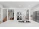 Beautiful kitchen features large island and stainless steel appliances, adjacent to staircase at 17449 Luminous Ave, Venice, FL 34293