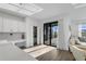 Open-concept living area with access to the backyard, featuring white walls, and wood floors at 17449 Luminous Ave, Venice, FL 34293