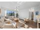 Bright, spacious living room features neutral decor and a large window offering scenic views at 17449 Luminous Ave, Venice, FL 34293