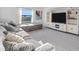 Comfortable living room featuring a large sectional sofa and entertainment center at 17449 Luminous Ave, Venice, FL 34293