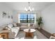 Bright living room features neutral decor, large windows, and modern lighting at 17449 Luminous Ave, Venice, FL 34293
