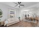 Inviting living room with a sofa, dining area, natural light, and modern fixtures at 17449 Luminous Ave, Venice, FL 34293