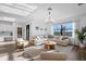 Bright living room with a comfortable sectional sofa, wood floors, and plenty of natural light at 17449 Luminous Ave, Venice, FL 34293