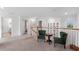 A beautifully furnished loft area with carpet flooring, white walls, and natural light from a window overlooking the backyard at 17449 Luminous Ave, Venice, FL 34293
