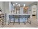 Contemporary kitchen features a breakfast bar with seating and pendant lighting at 1783 San Silvestro Drive, Venice, FL 34285