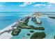 Panoramic aerial view of a coastal area with beautiful waterways, sandy beaches, lush greenery, and luxurious homes, creating a serene paradise at 1837 Upper Cove Ter, Sarasota, FL 34231