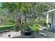 Lush backyard showcasing a tranquil water feature, mature trees, and serene landscaping at 1837 Upper Cove Ter, Sarasota, FL 34231