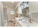 Bathroom with double sink vanity, modern lighting, and shower/bath at 1837 Upper Cove Ter, Sarasota, FL 34231