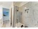 Bathroom featuring a bathtub, marble-style tile, and niche at 1837 Upper Cove Ter, Sarasota, FL 34231