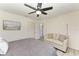 Bedroom with queen bed, small sitting area, and beach themed artwork at 1837 Upper Cove Ter, Sarasota, FL 34231