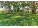 Charming single-story home featuring lush landscaping, mature trees and a well-manicured lawn at 1837 Upper Cove Ter, Sarasota, FL 34231