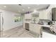 Bright kitchen with stainless steel appliances, quartz countertops, and custom cabinetry at 1837 Upper Cove Ter, Sarasota, FL 34231