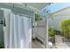 Outdoor shower with a privacy screen, tropical plants, and decorative elements for a refreshing experience at 1837 Upper Cove Ter, Sarasota, FL 34231