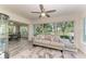 Relaxing sunroom with a cozy sofa and large windows offering a serene backyard view at 1837 Upper Cove Ter, Sarasota, FL 34231