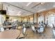 Bright dining room featuring round tables, comfortable seating, and elegant lighting fixtures at 18900 Bianchi St, Venice, FL 34293