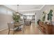 Dining area with tile flooring, modern light fixture, and open view to the kitchen at 19180 Mangieri St, Venice, FL 34293