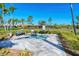 A tranquil hot tub with paved surroundings, shrubbery, and lounge bench offers a relaxing spa-like experience at 19180 Mangieri St, Venice, FL 34293