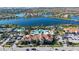Aerial view of community amenity center including a pool, clubhouse, tennis courts, and expansive surrounding neighborhood at 19651 Quisto St, Venice, FL 34293