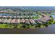 Wide aerial shot of the real estate with water view and meticulously maintained neighborhood and community at 19651 Quisto St, Venice, FL 34293