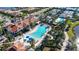 Aerial view of community amenity center including a pool, clubhouse, tennis courts and lush landscaping at 19651 Quisto St, Venice, FL 34293