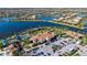 Aerial view of the amenity center, parking lot, tennis courts, and a waterfront area in a community at 19651 Quisto St, Venice, FL 34293