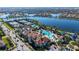 Aerial view of amenity center, tennis courts, lush landscaping, parking and waterfront in a beautiful community at 19651 Quisto St, Venice, FL 34293