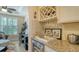 Wet bar boasts granite countertops, wine storage, and beverage cooler, perfect for entertaining friends and Gathering at 19651 Quisto St, Venice, FL 34293