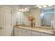 A luxurious bathroom with double sinks, granite countertops, and ample cabinet space at 19651 Quisto St, Venice, FL 34293