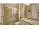 Elegant bathroom featuring granite countertop, tiled shower, and neutral walls at 19651 Quisto St, Venice, FL 34293