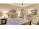 Cozy bedroom with a decorative bedspread, neutral walls, and ample natural light at 19651 Quisto St, Venice, FL 34293