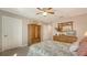 Bedroom features light colored walls, carpet, dresser, ceiling fan, and neutral walls at 19651 Quisto St, Venice, FL 34293