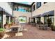 Charming courtyard with outdoor seating, brick pavers, and shade awnings offers a pleasant and inviting space at 19651 Quisto St, Venice, FL 34293