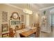 A dining room featuring wood furniture, decorative lighting, and neutral wall colors at 19651 Quisto St, Venice, FL 34293