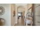 Open foyer with tiled floors, archways, and sightlines into the dining room, making a warm welcome at 19651 Quisto St, Venice, FL 34293