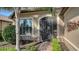 Close-up of the front entrance with a decorative security door, beautiful plants and meticulous landscaping at 19651 Quisto St, Venice, FL 34293