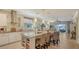 A modern kitchen featuring an island with seating, stainless steel appliances, and an open layout at 19651 Quisto St, Venice, FL 34293
