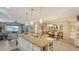 Open kitchen with large island, granite countertops, dining area, and access to the living room at 19651 Quisto St, Venice, FL 34293