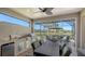 An outdoor lanai featuring a full outdoor kitchen, dining area, and a view of the water at 19651 Quisto St, Venice, FL 34293