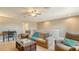 Upstairs living area features sofa, chair, and desk with neutral walls and carpet at 19651 Quisto St, Venice, FL 34293