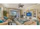 Bright living room featuring comfortable seating, decorative lighting, and access to the screened lanai at 19651 Quisto St, Venice, FL 34293
