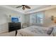 Calming primary bedroom with an accent wall, soft carpet and a ceiling fan at 19651 Quisto St, Venice, FL 34293