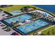 Aerial view of pickleball courts, well-maintained landscaping, and surrounding greenery at 19651 Quisto St, Venice, FL 34293