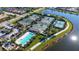 Aerial view showcasing multiple tennis courts, a swimming pool, and lush landscaping near a community of homes at 19651 Quisto St, Venice, FL 34293