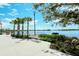 Community waterfront view, with palm trees and a serene lake, and a nice bench at 19651 Quisto St, Venice, FL 34293