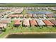 Community aerial view featuring a scenic lake and homes with lush landscaping in a vibrant neighborhood at 20389 Minuet Pl, Venice, FL 34293