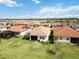 Drone shot displays the property's generous lawn, screened lanai, and the peaceful community setting at 20389 Minuet Pl, Venice, FL 34293